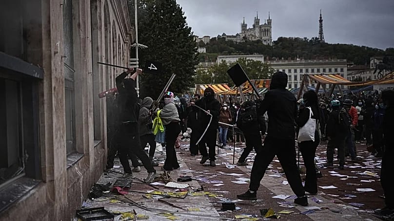 Protesters attack a tourism office during a demonstration against rising living costs, joining students' grievances, in Lyon, France, Saturday, Oct. 17, 2026.
