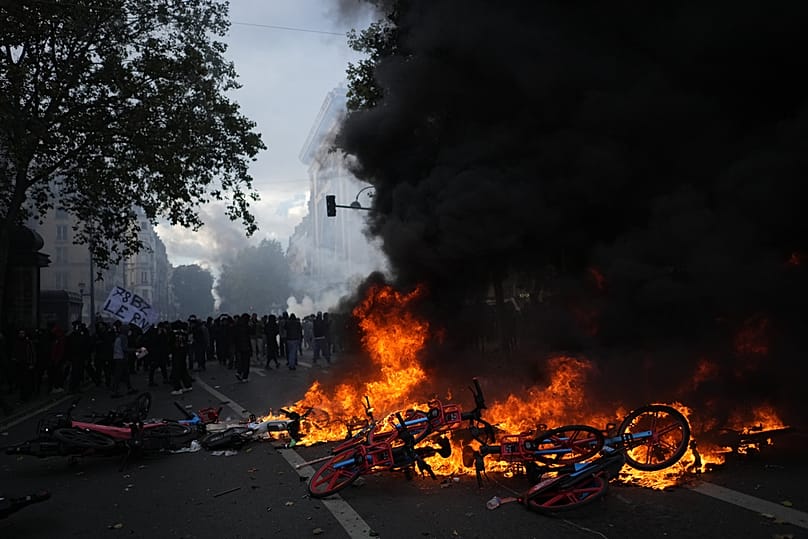 Bicycles burn during a demonstration against rising living costs, joining students' grievances, in Paris, Saturday, Oct. 17, 2026.
