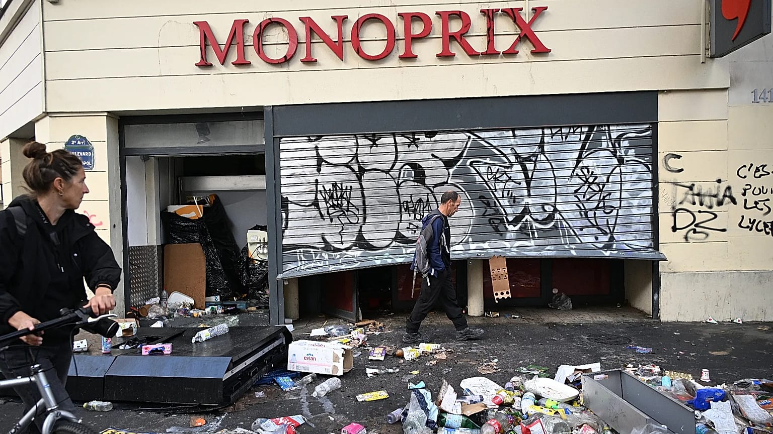 A man walks past a looted store the day after a demonstration against rising living costs and in solidarity with students’ grievances, in Paris, Sunday, 18 Oct. 2026. 