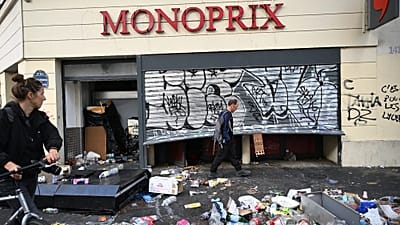 Un homme passe devant un magasin pillé, au lendemain d'une manifestation contre la hausse du coût de la vie et en soutien aux étudiants, à Paris, le 18 octobre 2026.