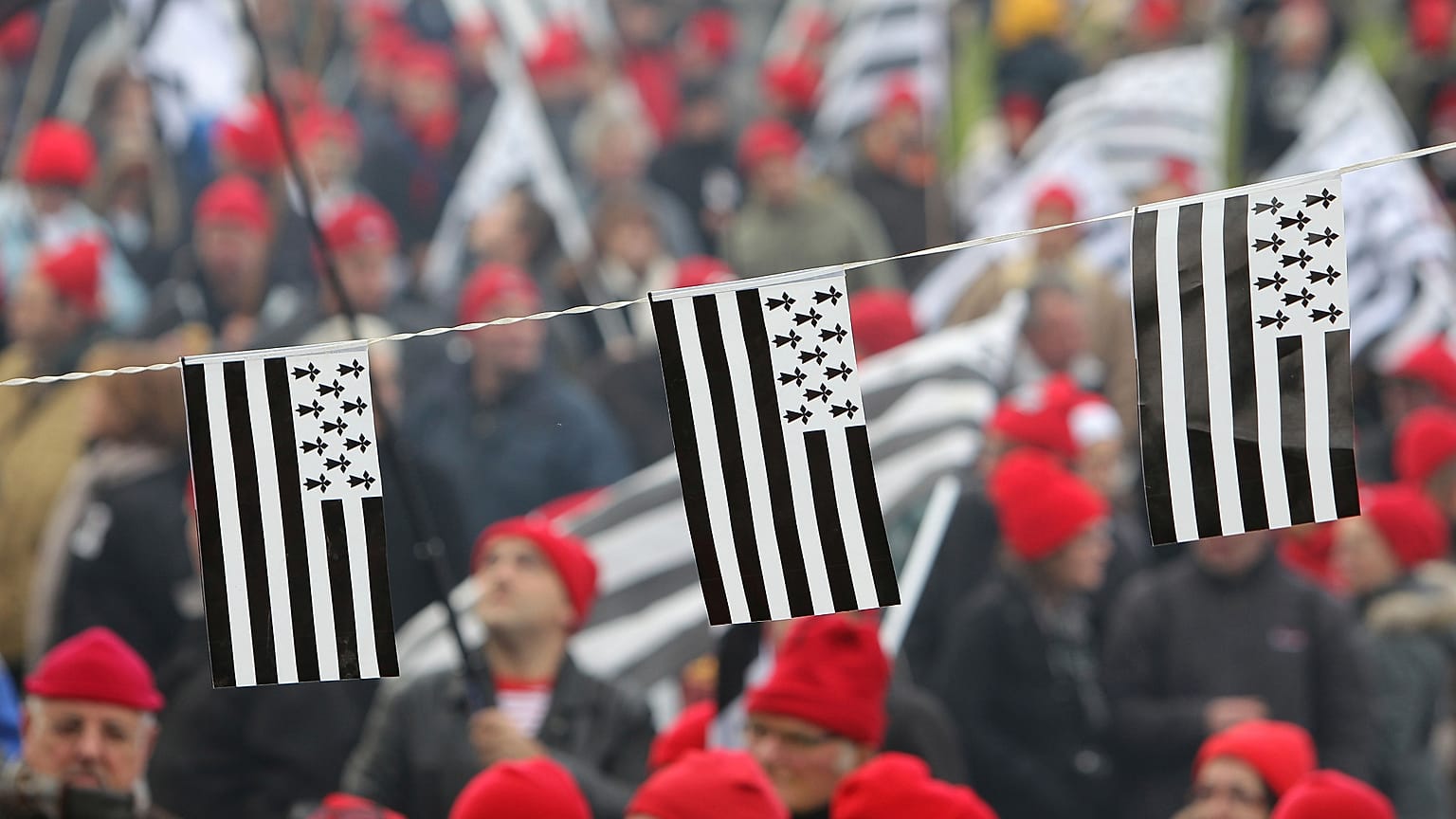 In this Nov.30, 2013, protesters wearing red hats and flags of Brittany take part a demonstration against job losses and against the government’s “eco-tax."