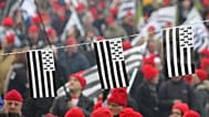 In this Nov.30, 2013, protesters wearing red hats and flags of Brittany take part a demonstration against job losses and against the government’s “eco-tax."