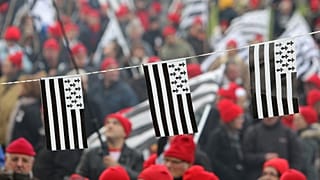 In this Nov.30, 2013, protesters wearing red hats and flags of Brittany take part a demonstration against job losses and against the government’s “eco-tax."