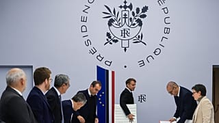 France's Ministers stand as President Emmanuel Macron arrives for an Interministerial Crisis Meeting at the Elysee Presidential Palace, Oct. 18, 2026 