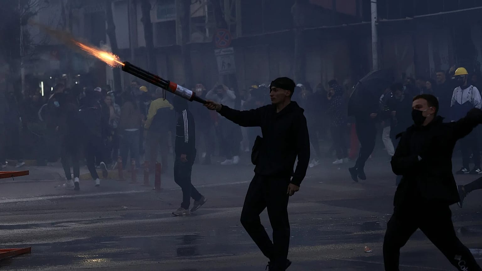A protester aims fireworks at police during clashes at an anti-government demonstration in Tirana, Albania, Sunday, Oct. 18, 2026.