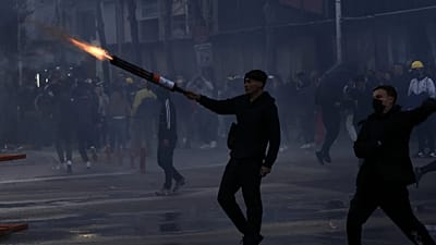 A protester aims fireworks at police during clashes at an anti-government demonstration in Tirana, Albania, Sunday, Oct. 18, 2026.