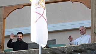 Ukraine's President Volodymyr Zelenskyy, left, and Pope Leo XIV wave to journalists during their meeting in Castel Gandolfo, Italy, Tuesday, Dec. 9, 2025