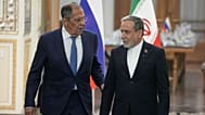 Iranian Foreign Minister Abbas Araghchi, right, and Russian Foreign Minister Sergey Lavrov arrive for a news conference in Tehran, Iran, Monday, Oct. 19, 2026.