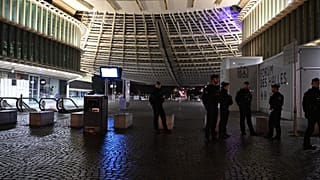 Policemen patrol during an overnight curfew in Paris, Tuesday, Oct. 20, 2026.