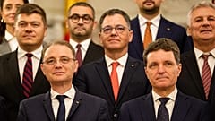 Prime Minister Luca Niculescu, left, smiles standing next to Romanian President Nicusor Dan after a swearing in ceremony for the new government 
