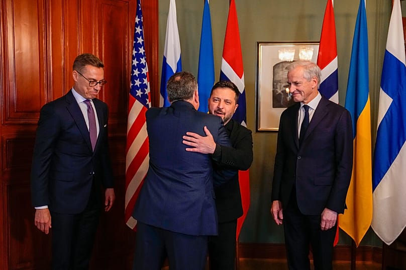 Ukrainian President Zelenskyy hugs US envoy Steve Witkoff as Norwegian PM Jonas Gahr Støre and Finnish President Alexander Stubb look on in Oslo, 20 October 2026.