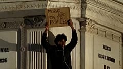 A man holds a sign reading ‘Housing must not be a privilege’ in Lisbon, Portugal, Tuesday, Oct. 20, 2026