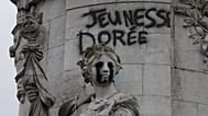 Tagging reading "The golden youth" on the statue of Equality at the Republique square, after a weekend of rioting and looting across France.