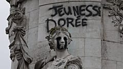 Tagging reading "The golden youth" on the statue of Equality at the Republique square, after a weekend of rioting and looting across France.