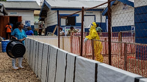A healthcare worker speaks to a colleague at the Ebola treatment center in Beni, North Kivu province, Congo.