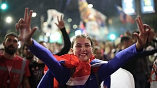 People welcome a group of students who have arrived ahead of a pre-election rally of "Student list - Students win" in Belgrade.