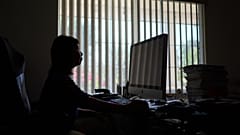 FILE — Alice Lin was the victim of an online scammer, pictured here sitting at her computer at home, Saturday, May 9, 2026, in Alhambra, Calif. 