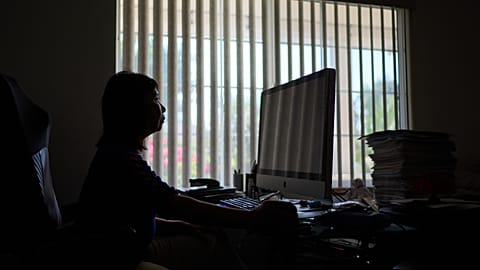FILE — Alice Lin was the victim of an online scammer, pictured here sitting at her computer at home, Saturday, May 9, 2026, in Alhambra, Calif. 