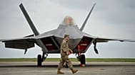 FILE: A US serviceman walks by a US Air Force F-22 Raptor fighter jet, 25 April 2015