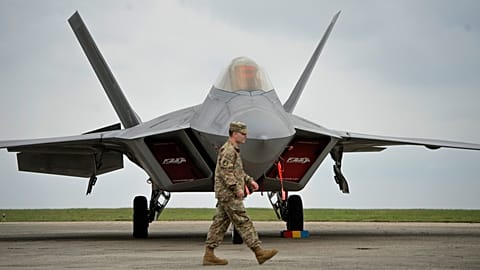 FILE: A US serviceman walks by a US Air Force F-22 Raptor fighter jet, 25 April 2015