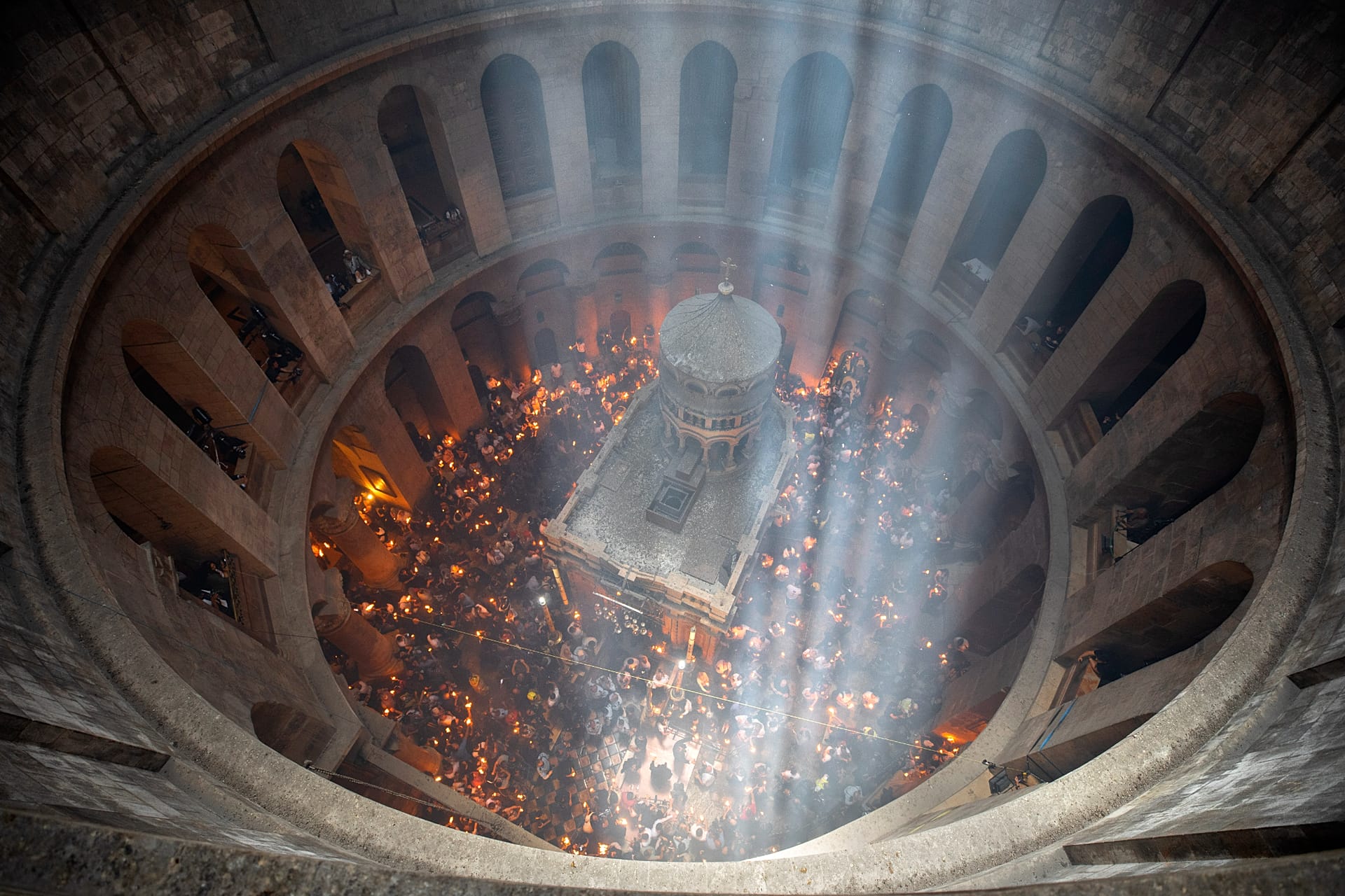 Christian pilgrims hold candles as they gather in the Church of the Holy Sepulchre in Jerusalem's Old City.