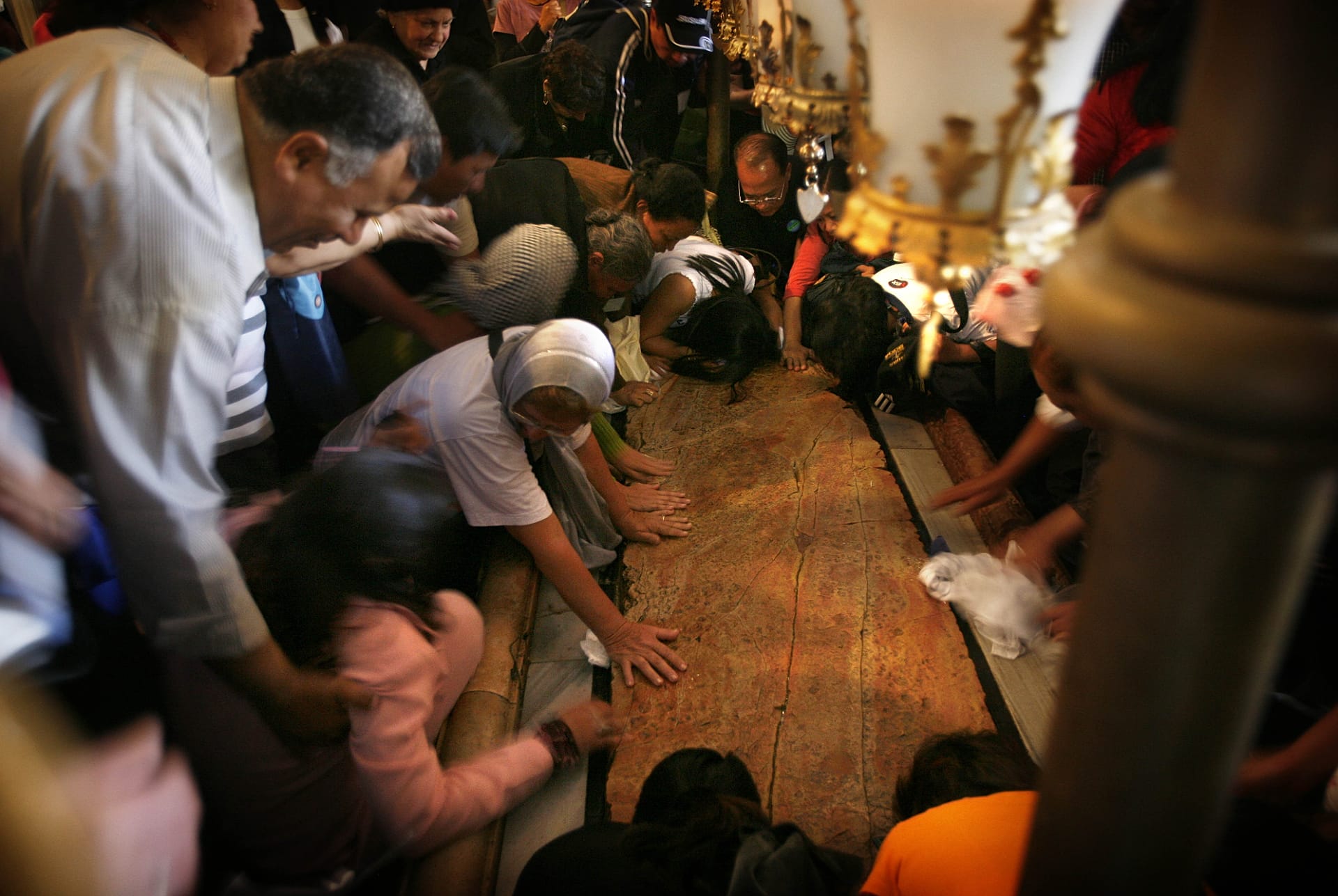 Christian worshippers pray at the stone on which, according to belief, Jesus Christ was washed after his crucifixion.
