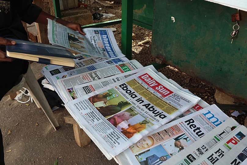 A man sells newspapers in Abuja, Nigeria Wednesday, Oct. 21, 2026. 