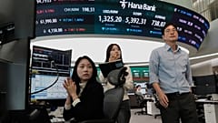 Currency traders work at the foreign exchange dealing room of the Hana Bank headquarters in Seoul, South Korea, Friday, 23 Oct. 2026. 