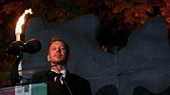 Hungarian Prime Minister Peter Magyar prepares to light the flame of revolution during the commemoration of the 70th anniversary of the outbreak of the Hungarian Revolution an