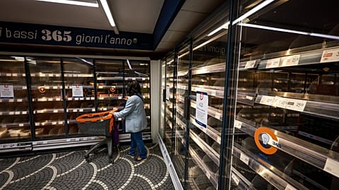 A woman looks at empty shelves in a supermarket following truckers protesting against high fuel prices, in Naples, Italy, Thursday Oct. 22, 2026.