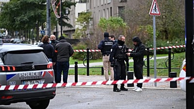 Police stand near a park after a shooting left one person dead and four others wounded in Trappes, outside Paris, Friday, Oct. 23, 2026.