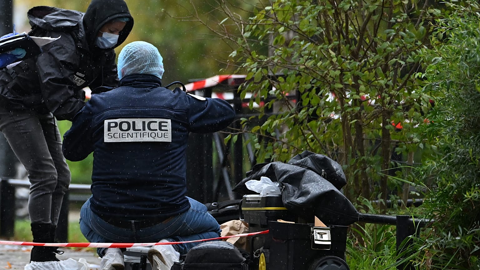 Forensic investigators search for evidence after a shooting in Trappes, outside Paris, Friday, Oct. 23, 2026