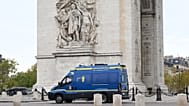 Police trucks are parked in front of the Arc de Triomphe ahead of a demonstration against rising living costs in Paris, Saturday, Oct. 24, 2026.