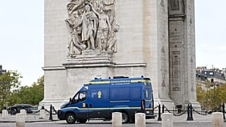 Police trucks are parked in front of the Arc de Triomphe ahead of a demonstration against rising living costs in Paris, Saturday, Oct. 24, 2026.