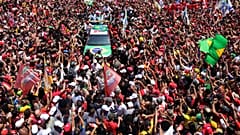 Brazilian President Luiz Inacio Lula da Silva, center, waves to supporters during his final campaign rally on Copacabana beach ahead of Brazil's presidential runoff election