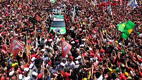 Brazilian President Luiz Inacio Lula da Silva, center, waves to supporters during his final campaign rally on Copacabana beach ahead of Brazil's presidential runoff election
