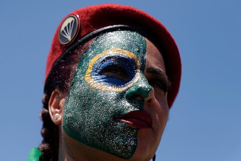 A supporter with her face painted in the colors of the Brazilian flag at the final campaign rally of opposition presidential candidate Sen. Flavio Bolsonaro, Rio de Jananeiro