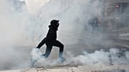 A protester throws a teargas canister to police after a demonstration against rising living costs in Rennes, France, Saturday, Oct. 24, 2026.