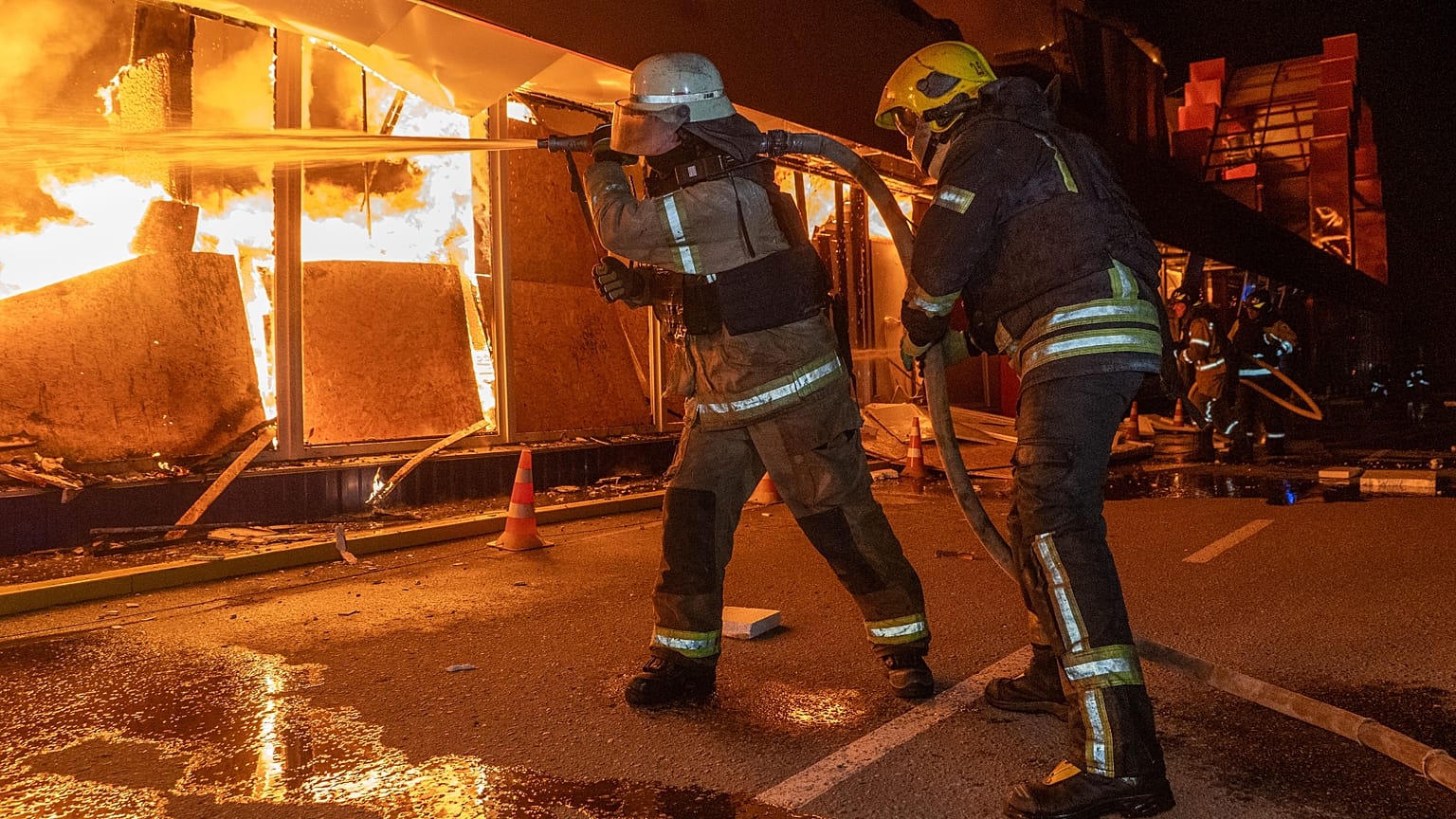 Firefighters try to put out a fire at a shopping store following Russia's air attack in Kharkiv, Ukraine, Sunday, Oct. 25, 2026.