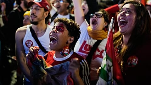 Supporters of President Luiz Inacio Lula da Silva, who is seeking reelection, cheer as presidential runoff results are announced in Sao Paulo.