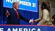 President Donald Trump, left, looks to Nicki Minaj as Minaj departs after speaking during a campaign rally in Port Huron