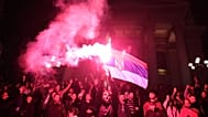 People celebrate outside the National Assembly, after Aleksandar Vucic, leader of the right-wing Serbian Progressive Party (SNS) conceded defeat in the parliamentary election.