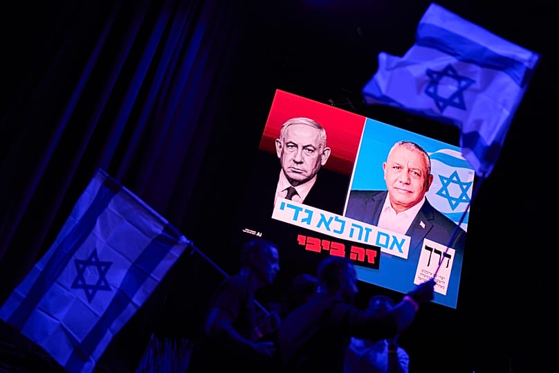 A screen projects an image of Israeli Prime Minister Benjamin Netanyahu, and opposition candidate Gadi Eisenkot, leader of the Yashar party, Oct. 25, 2026