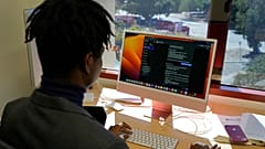 Post-doctoral researcher Tofunmi Omiye looks over chatbots in his office at the Stanford School of Medicine in Stanford, Calif., Tuesday, Oct. 17, 2023.