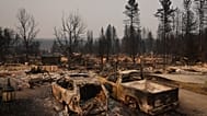 Dozens of homes are seen burned to the ground after a wildfire hit the northern part of Spokane, Wash., Monday, Aug. 3, 2026. 