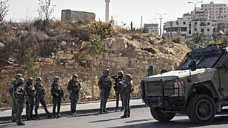 جنود إسرائيليون يتجمعون في موقع هجوم بإطلاق نار نفذه مسلحون فلسطينيون عند تقاطع طرق قرب مدينة الخليل في الضفة الغربية المحتلة، يوم الجمعة 23 أكتوبر 2026. (صورة من أسوشيتد برس/