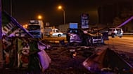 Emergency workers clear debris and damaged road infrastructure near a destroyed car following a Russian overnight strike in Kyiv, Ukraine, Tuesday, Oct. 27, 2026. 