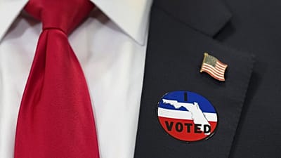 Trump wears an "I voted" badge