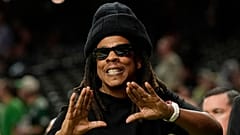 FILE - Jay-Z gestures from the sidelines prior to the NFL Super Bowl 59 football game, 9 Feb 2025, in New Orleans.