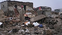A man inspects the aftermath of a Jordanian airstrike in Al-Tuff, in the countryside of Daraa province in southern Syria, Tuesday, Oct. 27, 2026.